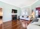 Comfortable living room with hardwood floors, fireplace, and access to the outdoor space at 28330 Openfield Loop, Wesley Chapel, FL 33543