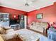 Comfortable living room with ceiling fan, plush sofas, and large entertainment center at 28330 Openfield Loop, Wesley Chapel, FL 33543