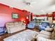 Cozy living room with plush sofas, hardwood floors, and adjacent kitchen area at 28330 Openfield Loop, Wesley Chapel, FL 33543