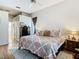 Inviting main bedroom with hardwood floors, neutral tones, and a comfortable bed at 28330 Openfield Loop, Wesley Chapel, FL 33543