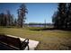 Serene park bench overlooking a peaceful lake at 3831 Evergreen Oaks Dr, Lutz, FL 33558
