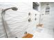 Elegant bathroom featuring wave-patterned tile and multiple shower heads at 3831 Evergreen Oaks Dr, Lutz, FL 33558