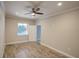 Bright bedroom with wood-look tile floors, ceiling fan and pool view at 3831 Evergreen Oaks Dr, Lutz, FL 33558