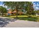 Two story house on a tree-lined street with lush green lawn at 3831 Evergreen Oaks Dr, Lutz, FL 33558