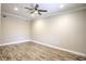 Spacious bedroom with wood-look tile flooring and ceiling fan at 3831 Evergreen Oaks Dr, Lutz, FL 33558