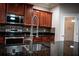 Modern kitchen features stainless steel appliances and granite countertops at 3831 Evergreen Oaks Dr, Lutz, FL 33558