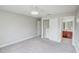 Well-lit bedroom featuring carpet flooring and an ensuite bathroom at 3831 Evergreen Oaks Dr, Lutz, FL 33558