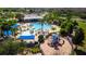 Community pool, playground, and clubhouse with surrounding landscape at 3831 Evergreen Oaks Dr, Lutz, FL 33558