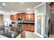 Modern kitchen with dark wood cabinets, granite countertops, and stainless steel appliances at 3831 Evergreen Oaks Dr, Lutz, FL 33558
