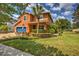Two story house with a blue garage door and manicured lawn at 3831 Evergreen Oaks Dr, Lutz, FL 33558