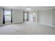 Main bedroom with carpet flooring, large windows and ensuite bath at 3831 Evergreen Oaks Dr, Lutz, FL 33558