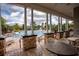 View of the community pool from covered patio with tables at 3831 Evergreen Oaks Dr, Lutz, FL 33558