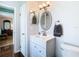 Clean bathroom with single sink vanity and oval mirror at 28330 Openfield Loop, Wesley Chapel, FL 33543