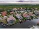 Aerial view showcasing waterfront homes, private docks, and lush greenery near the open bay at 5510 E Longboat Blvd, Tampa, FL 33615