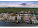 Beautiful aerial view of waterfront homes with private docks and swimming pools at sunset at 5510 E Longboat Blvd, Tampa, FL 33615