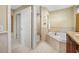 Primary bathroom featuring a soaking tub, tiled walls, and a separate glass shower at 5510 E Longboat Blvd, Tampa, FL 33615