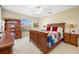Bright bedroom featuring a wooden bed frame, ceiling fan, and matching wooden desk and dresser at 5510 E Longboat Blvd, Tampa, FL 33615