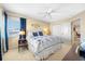 Bright bedroom with neutral colored walls, a ceiling fan, closet, and blue accents at 5510 E Longboat Blvd, Tampa, FL 33615