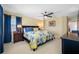 Comfortable bedroom featuring a ceiling fan, a large window, and carpet flooring at 5510 E Longboat Blvd, Tampa, FL 33615