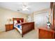 Bedroom with wooden furniture, neutral carpet, and white closet with three doors at 5510 E Longboat Blvd, Tampa, FL 33615