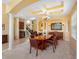 Elegant dining room featuring columns, coffered ceilings, and butlers pantry at 5510 E Longboat Blvd, Tampa, FL 33615