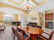 Elegant dining room featuring a chandelier, coffered ceilings, and butlers pantry at 5510 E Longboat Blvd, Tampa, FL 33615