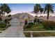 Charming two-story home featuring a three-car garage, well-manicured lawn, and mature palm trees at 5510 E Longboat Blvd, Tampa, FL 33615