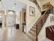 Welcoming foyer with grand staircase, wet bar, and elegant double doors at 5510 E Longboat Blvd, Tampa, FL 33615
