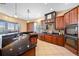 Gourmet kitchen with custom wood cabinetry, granite countertops, stainless steel appliances, and tile flooring at 5510 E Longboat Blvd, Tampa, FL 33615