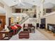 Open-concept living room with a fireplace, staircase, a view to the mezzanine, and lots of natural light at 5510 E Longboat Blvd, Tampa, FL 33615
