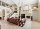Inviting living room featuring high ceilings, a cozy fireplace, and a staircase with iron railings at 5510 E Longboat Blvd, Tampa, FL 33615