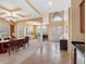 Spacious living space featuring elegant columns, a dining table, a piano, and large windows that provide ample natural light at 5510 E Longboat Blvd, Tampa, FL 33615