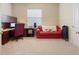 Cozy home office with carpet flooring, a comfortable sofa, a built-in desk, and ample natural light at 5510 E Longboat Blvd, Tampa, FL 33615