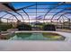 Sparkling in-ground pool inside a screened enclosure providing serene waterfront views at 5510 E Longboat Blvd, Tampa, FL 33615