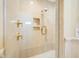 Walk-in shower stall with neutral tile, gold hardware, and integrated shelving at 5510 E Longboat Blvd, Tampa, FL 33615