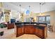 Island kitchen with granite counters, double ovens, and a view into the living room at 5510 E Longboat Blvd, Tampa, FL 33615