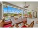Outdoor dining area with seating, adjacent to the pool at 5510 E Longboat Blvd, Tampa, FL 33615