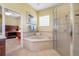 Bathroom with corner soaking tub and separate shower at 5510 E Longboat Blvd, Tampa, FL 33615