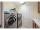 Laundry room features built-in shelving and a new washer and dryer at 5510 E Longboat Blvd, Tampa, FL 33615