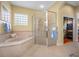 Bathroom featuring a soaking tub, shower, and tile flooring at 5510 E Longboat Blvd, Tampa, FL 33615