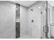 This bathroom features a glass shower with decorative tile, modern fixtures, and a niche at 11734 Orange Ct, Dade City, FL 33525