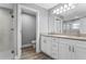This bathroom showcases a double vanity with granite countertops and a glass-enclosed shower at 11734 Orange Ct, Dade City, FL 33525