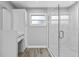 This bathroom features wood tile floors, a glass shower, and a vanity area at 11734 Orange Ct, Dade City, FL 33525