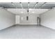 Clean and spacious two car garage with gray epoxy flooring and ample room for storage at 11734 Orange Ct, Dade City, FL 33525