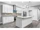 Bright kitchen with island, stainless steel appliances, granite countertops, and white cabinetry at 11734 Orange Ct, Dade City, FL 33525