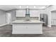 Modern kitchen featuring an island, granite countertops, stainless steel appliances, and white cabinets at 11734 Orange Ct, Dade City, FL 33525