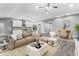 Open concept living and dining area with views of the kitchen and hardwood floors at 11734 Orange Ct, Dade City, FL 33525