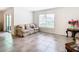 Living area with tile floors, sofa, and sliding glass door at 13292 Golden Lime Ave, Spring Hill, FL 34609