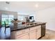 Kitchen island with granite countertops, stainless steel appliances, and view to backyard at 13292 Golden Lime Ave, Spring Hill, FL 34609