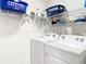 Laundry room with washer, dryer, and shelving at 13292 Golden Lime Ave, Spring Hill, FL 34609
